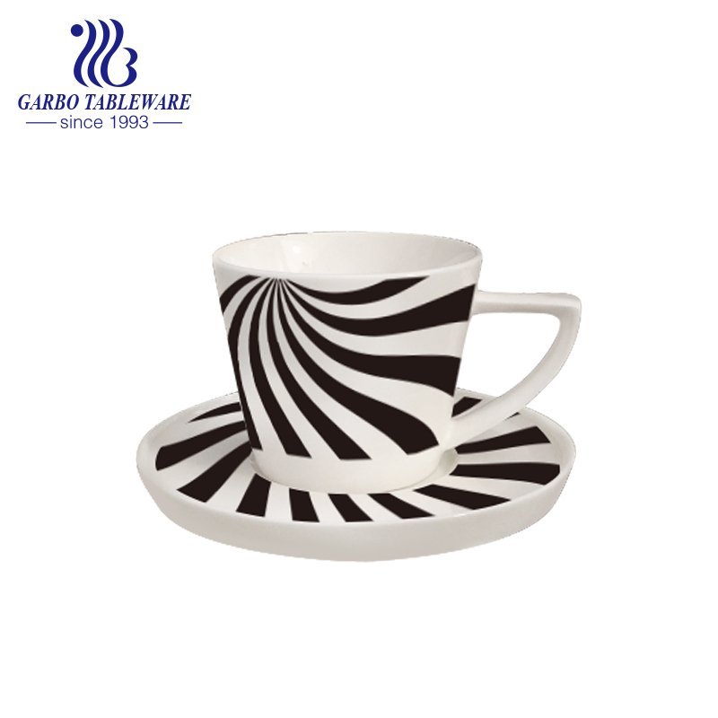 Triangle handle tea cup and saucer set with design