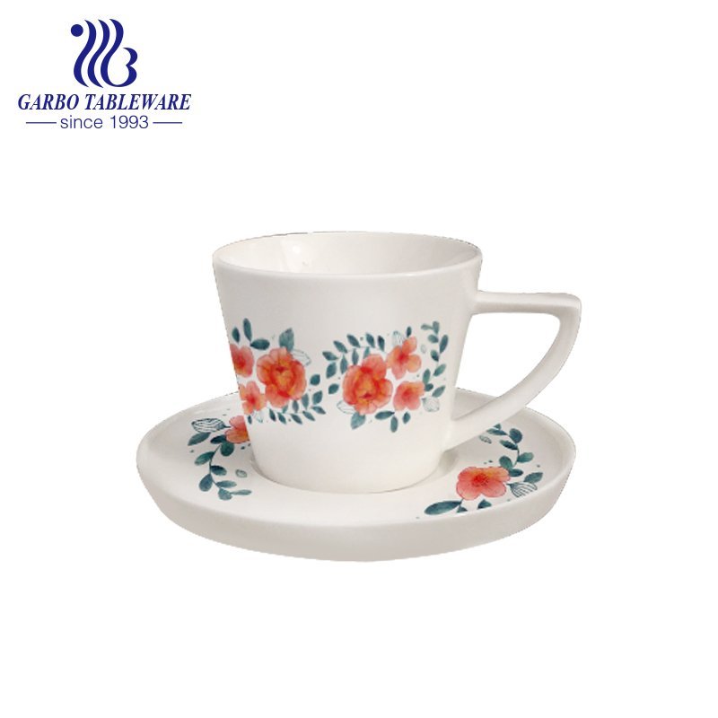 Triangle handle tea cup and saucer set with design