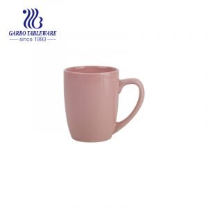 Color glazed pink ceramic mug for drinking coffee with handle for home