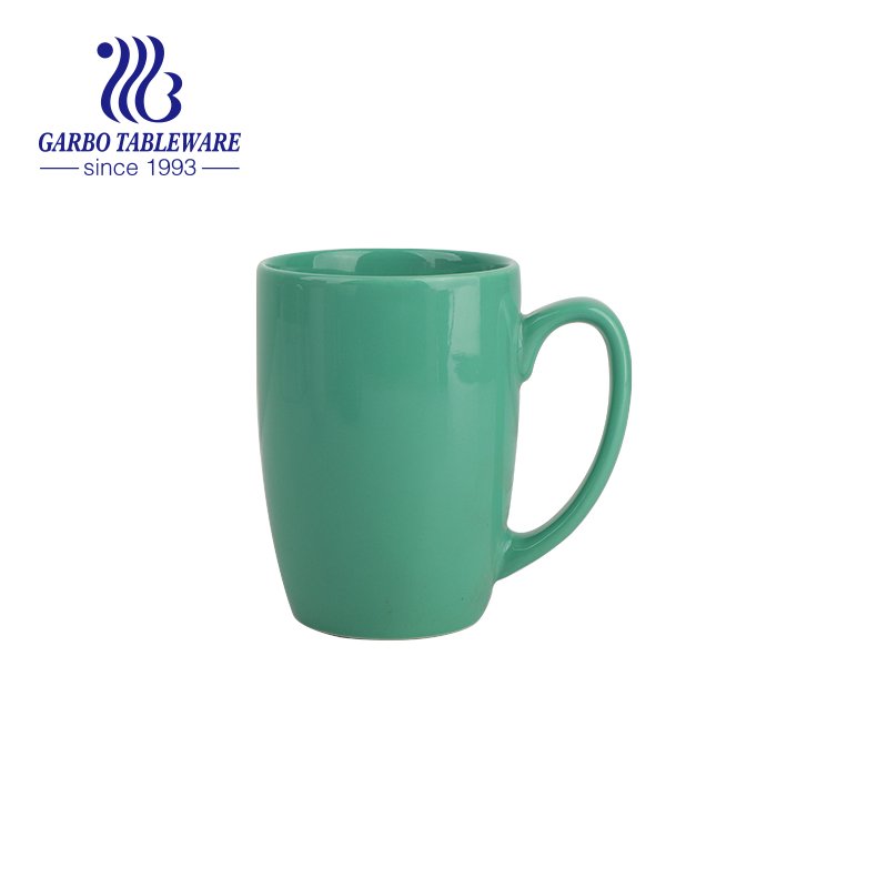 Color glazed pink ceramic mug for drinking coffee with handle for home