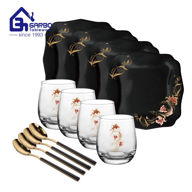 Black opal dinner plates set with gold spoons and stemless glass cup